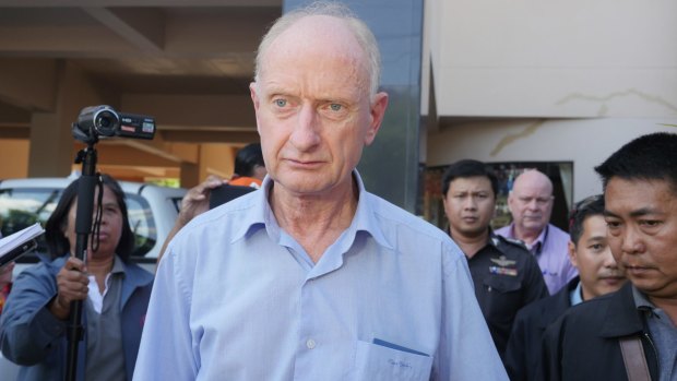 Peter Dundas Walbran with police after his arrest in Ubon Ratchathani, Thailand, on Wednesday.