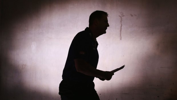 Dockers coach Ross Lyon heads out to meet his players at half-time.