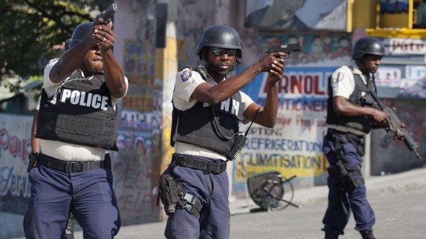 National police fire towards demonstrators during a protest against official presidential election results in Port-au-Prince, Haiti, on  Tuesday.