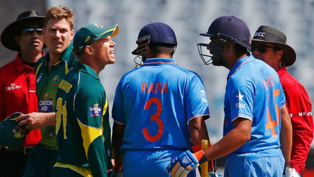 Having words: David Warner and India's Rohit Sharma (second from right) have an animated chat during the one-day series in January.