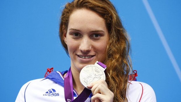 France's Camille Muffat, one of the 10 who died in the helicopter crash, poses with her silver medal after placing second in the women's 200m freestyle final with an Olympic record during the London 2012 Olympic Games. 