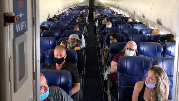 Masked passengers fill a Southwest Airlines flight from Burbank, California, to Las Vegas, with middle seats left open. 
