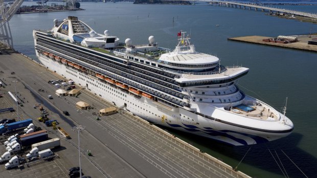 Tents stand on a wharf near the Grand Princess at the Port of Oakland, California. The cruise ship, which had maintained a holding pattern off the coast for days, is carrying multiple people who tested positive  for COVID-19.