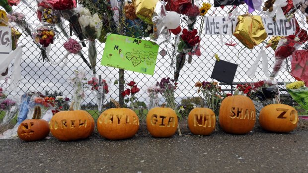 The victims' names are carved into Halloween pumpkins at the memorial at Marysville-Pilchuck High School. 