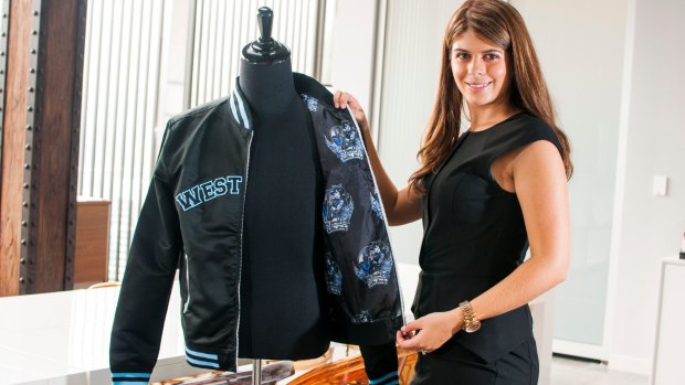 Elyse Daniels, founder of Exodus Wear, shows off one of the company's bomber jackets.