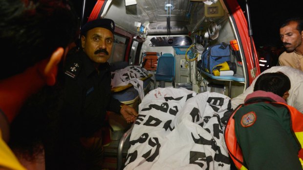 Volunteers and paramedics help at the scene of the attack, which has been claimed by the Taliban.