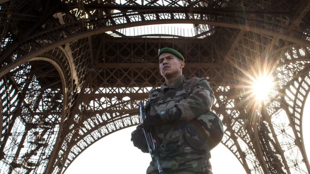 A French soldier stands guard at Eiffel Tower in Paris. 