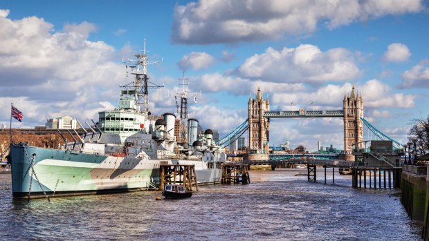HMS Belfast on the River Thames, and Tower Bridge, London.