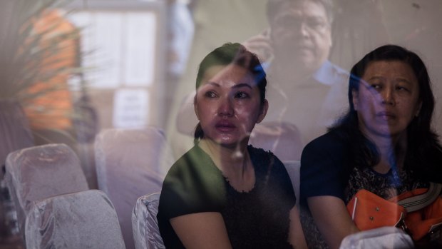 Family members of QZ8501 passengers wait for news at the crisis centre in Surabaya.