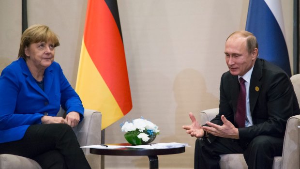 German Chancellor Angela Merkel reacts as she listens to Russian President Vladimir Putin during their talks at the G-20 Summit in Turkey in 2015. 