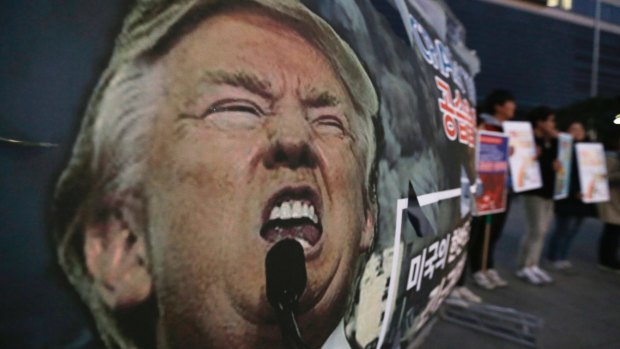 A portrait of US President Donald Trump is displayed as South Korean protesters stage a rally denouncing the United States's policy against North Korea near the US embassy in Seoul, South Korea.