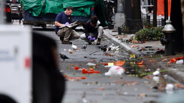 Evidence teams investigate at the scene of Saturday's explosion in Manhattan's Chelsea neighbourhood.