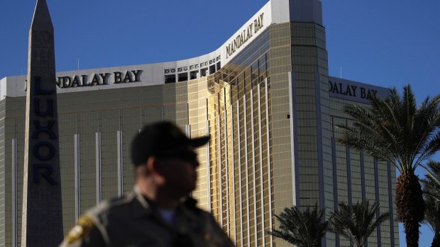 A Las Vegas police officer stands by a blocked off area near the Mandalay Bay casino in Las Vegas.