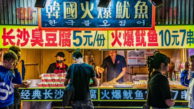 Night market street food stalls at Sanxiajiu Pedestrian street in the downtown area.