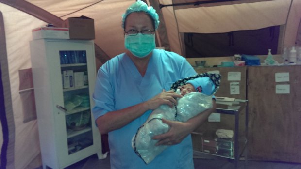 Dr Jenny Stedmon attends to a new born baby at the Red Cross field hospital in Dhunche, Nepal, set up after the earthquakes.