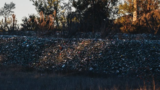 The piles of glass from ACT recycling bins dumped near the Federal Highway at Lake George.