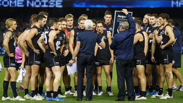 Back to the wall: Blues coach Mick Malthouse with his players during the game against GWS.