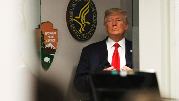President Donald Trump adjusts his jacket before taking a tour of the Federal Emergency Management Agency headquarters in Washington earlier in August.
