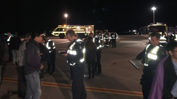 Passengers from the Malaysia Airlines plane on the tarmac.