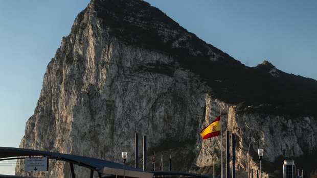 A Spanish flag flies on the top of the customs house on the Spanish side of the border.