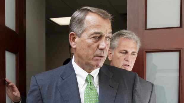 Stepping down ... House Speaker John Boehner, left, followed by House Majority Leader Kevin McCarthy, emerge from a meeting on Capitol Hill in Washington.