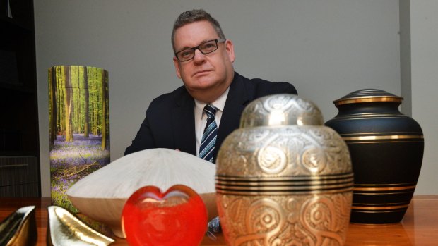 General manager of Tobin Brothers funerals Nick Fogarty with modern urns.