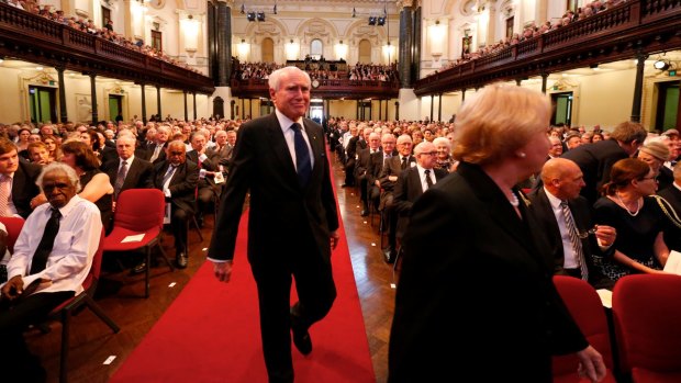 Former prime minister John Howard takes his seat at Gough Whitlam's state memorial service.