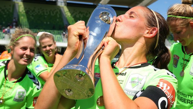 Canberra United captain Nicole Begg kisses the championship trophy after last year's grand final victory.