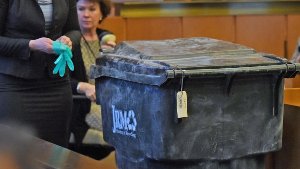 Assistant District Attorney Kate McDougall, left, with a recycling bin that was introduced as evidence during Philip Chism's trial.