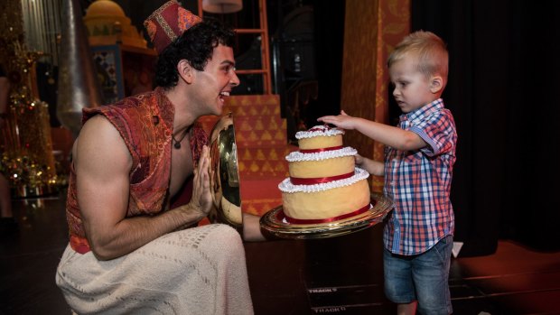 Backstage: Cruz Taplin, 4, inspects the props before the special matinee performance of Disney's Aladdin The Musical.