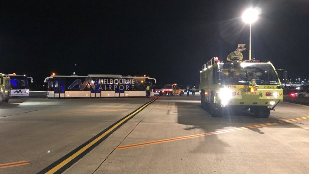 A police vehicle on the tarmac after a man allegedly tried to enter the cockpit of Malaysia Airlines Flight MH128.