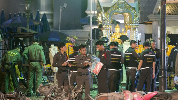 Police investigate the scene of the first, deadly bombing at the Erawan Shrine.