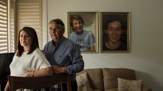 Kathy and Ralph Kelly at home with photos of sons Thomas (left) and Stuart (right).