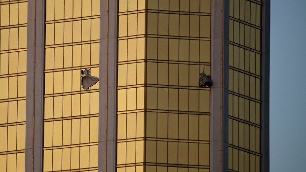 Curtains billow out of broken windows at the Las Vegas Mandalay Bay resort and casino from where Stephen Paddock shot festival goers. 