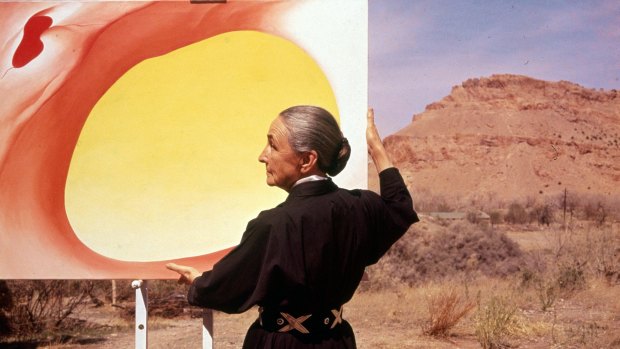 Artist Georgia O'Keeffe (1887-1986) with a canvas from her 'Pelvis Series - Red With Yellow', Albuquerque, New Mexico, 1960. 