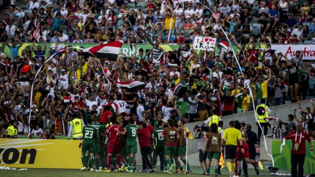 Great stadium, electric atmosphere: Iraq celebrate scoring a goal during extra time against Iran.