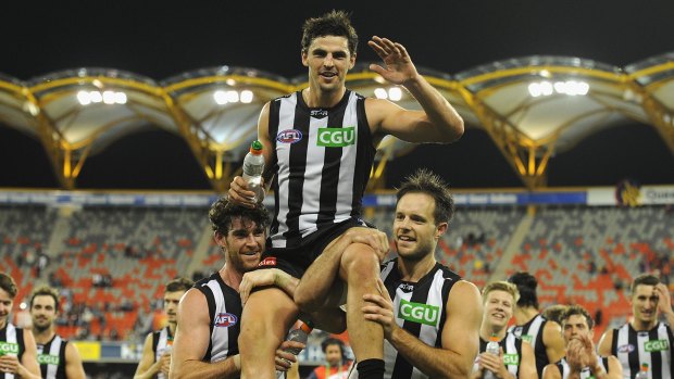 Collingwood captain Scott Pendlebury is chaired from the field after starring in his 200th AFL match.
