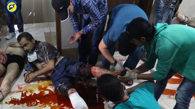 Victims of air strikes receive treatment on the floor of a clinic in Aleppo on Sunday. 
