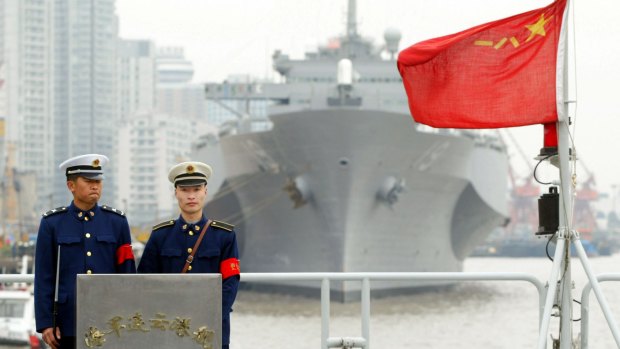 Two Chinese soldiers stand guard on the warship Lianyungang in 2004. 