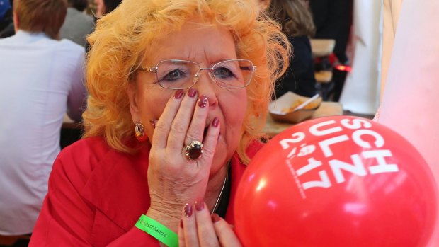 A Social Democrats supporter watches the results come in.