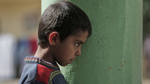 A Syrian Kurdish child who fled Kobane stands in the grounds of a mosque where his family found refuge in the Turkish town of Suruc.