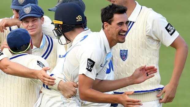 NSW's Mitchell Starc celebrates with teammates after dismissing David Moody on Tuesday.