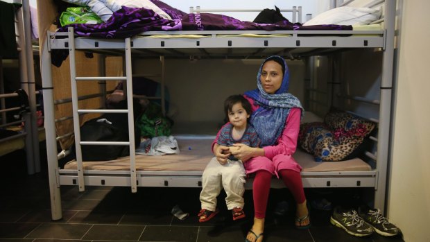 The ongoing war in Afghanistan means that many Afghans are among the hundreds of thousands of people seeking refuge in Europe. Here, an Afghan mother and child sit on their bunk bed at the Tempelhof refugee camp in Berlin.