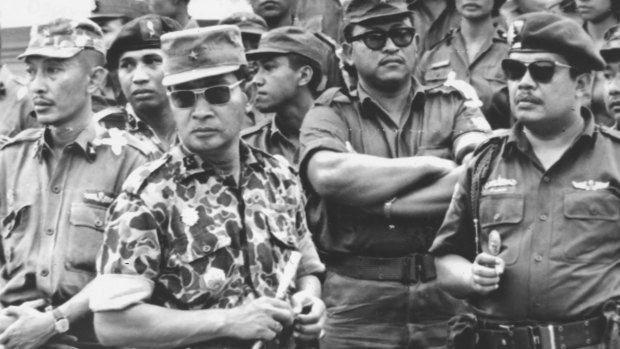 Suharto (in patterned uniform) at the funeral of the slain generals in 1965, an event that precipitated a massive purge against communits, real and perceived.