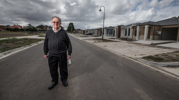 Jack Mercovich in front of a row of new housing in his suburb of South Morang. 