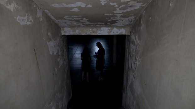 Women stand in the basement that served as an admitting area for detainees at the former Argentine Navy School of Mechanics in Buenos Aires.