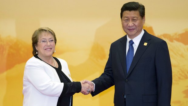 Chilean President Michelle Bachelet shakes hands with Chinese President Xi Jinping during a welcome ceremony for the Asia-Pacific Economic Co-operation summit  in Yanqi Lake, Beijing, in November 2014.