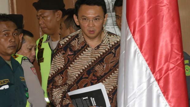 Ahok, centre, enters the courtroom on Tuesday.