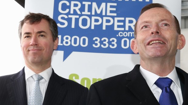 Justice Minister Michael Keenan and Prime Minister Tony Abbott at an AFP training facility in Canberra on Monday.