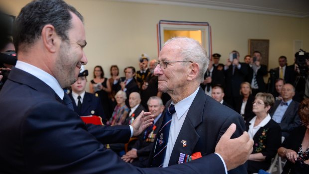 Donald McDonald receives the Legion of Honour from French Ambassador Christophe Lecourtier.